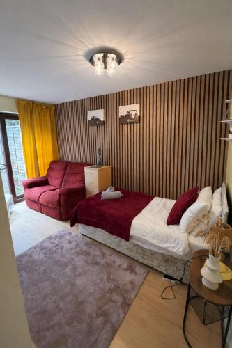 a bedroom with a large bed and a couch at Real Home In Northampton in Overstone