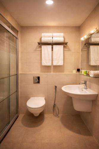 a bathroom with a toilet and a sink at Panorama Amman Hotel in Amman