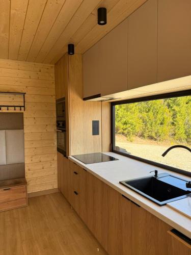 a kitchen with a sink and a window at Dom z Widokiem na Tatry- Luxury Chalet in Klikuszowa
