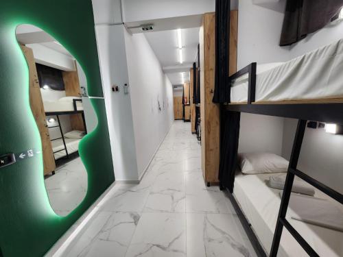 a corridor of a dorm room with bunk beds at The HANGOUT Hostel in Sarandë