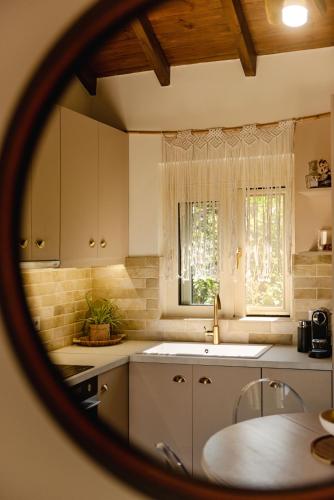 a kitchen with white cabinets and a sink at Petit Palace in Lefkimmi