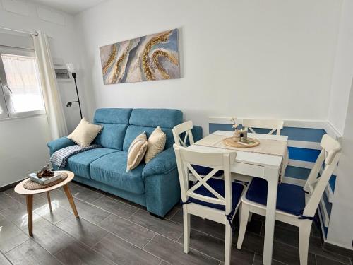 a living room with a blue couch and a table at Apartamento Maravía La Restinga in La Restinga