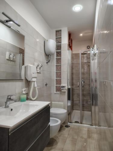 a bathroom with a sink and a toilet and a shower at B&B Maestra Giovanna in Pompei