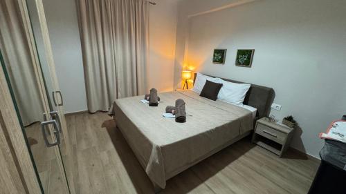 a bedroom with a bed with a pair of shoes on it at imvros home luxury in Alexandroupoli