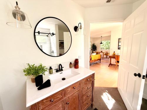 a bathroom with a sink and a mirror on the wall at Charming Private Cottage in Ojai in Ojai