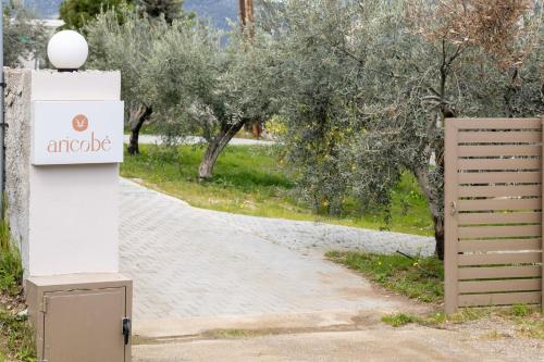an apple sign next to a road with trees at Aricobé in Ancient Epidauros