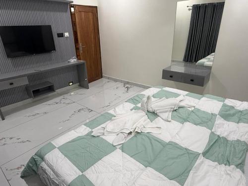a bedroom with a large bed with a tv on it at Mangro villa in Mayyanād