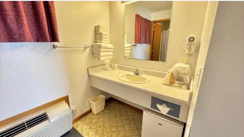a bathroom with a sink and a mirror at North Winds Lodge LLC in Bowman