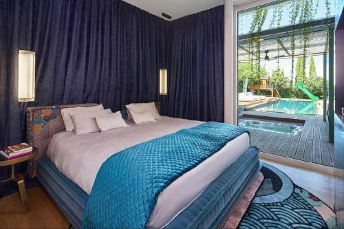 a bedroom with a large bed and a swimming pool at כוכב קיסר in Caesarea