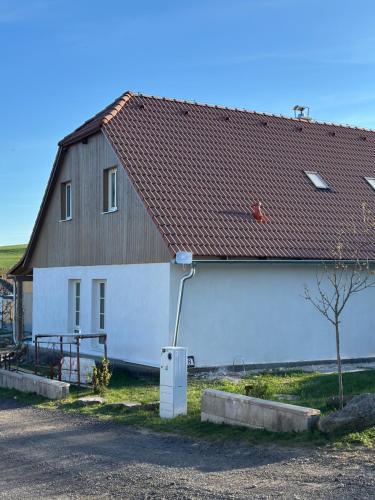 a large white house with a brown roof at Brezový dvor in Svätý Anton