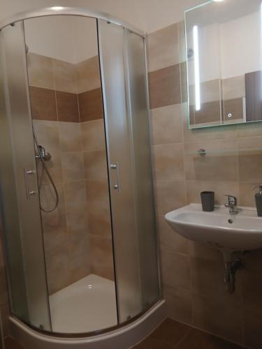 a bathroom with a shower and a sink at Apartments Orange in Uherské Hradiště