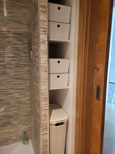 a bathroom with a toilet and a shower at Luxury Ground Floor Apartment at Golf Resort Condado de Alhama with Private Garden & Pools in El Romero
