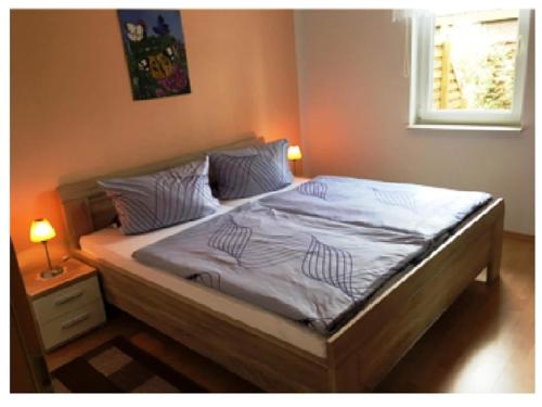 a bedroom with a bed with white sheets and a window at Gemuetliche Doppelhaushälfte in Lubmin in Lubmin