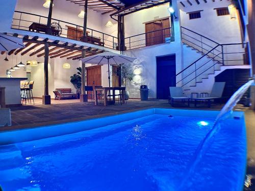 a swimming pool in front of a house with a staircase at Casa Mónica Barichara in Barichara