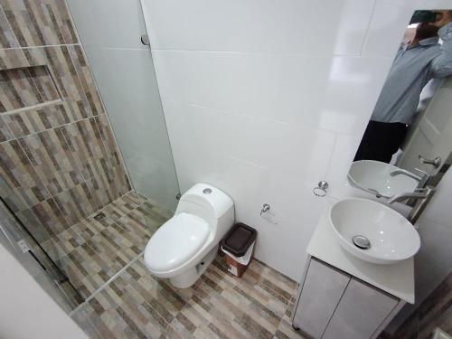 a bathroom with a toilet and a sink and a shower at Casa Palma Poblado in Medellín