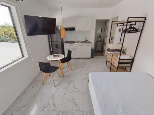 a kitchen and living room with a table and chairs at Casa Palma Poblado in Medellín
