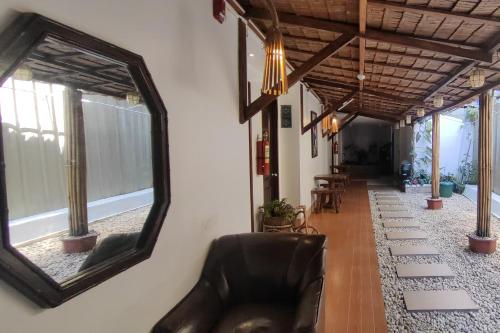 a mirror on a wall with a couch in a hallway at Liane's Place Puerto Princesa in Puerto Princesa City