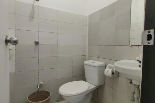a bathroom with a toilet and a sink at Liane's Place Puerto Princesa in Puerto Princesa City