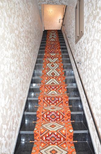 a stairway with an orange patterned carpet at Residence 33 orange in Guelmim