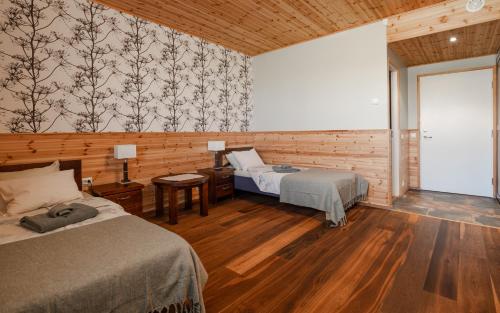 a bedroom with two beds and a large window at Eistvere Puhkemaja in Eistvere