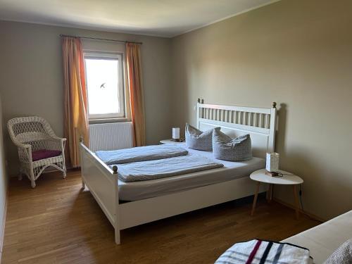 a bedroom with a white bed and a window at Gasthaus Schwielochsee in Friedland