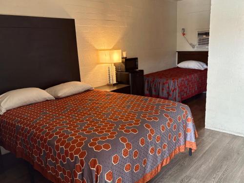 a hotel room with two beds in a room at Border Motel in Calexico