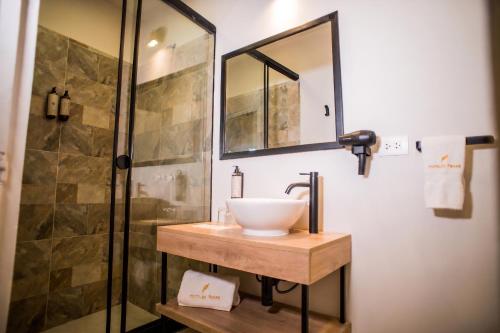 a bathroom with a sink and a shower at Hotel Ferre Cusco in Cusco