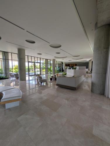 a large lobby with tables and chairs in a building at Manzanillo Loft Morros EOS in Cartagena de Indias