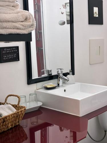 a bathroom with a white sink and a mirror at Refúgio da Vila - Refuge of the Village in Vouzela