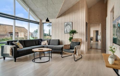 a living room with a couch and two chairs at Nice Home In Ringkøbing With Sauna in Ringkøbing