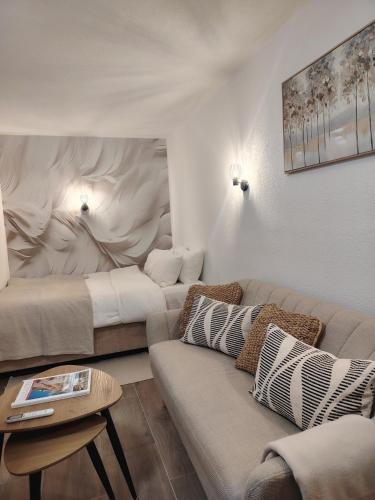 a living room with two beds and a couch at Studio BIANCA in Kotor