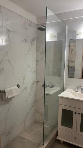 a bathroom with a shower and a sink at Maison Apart Hotel in Mar del Plata