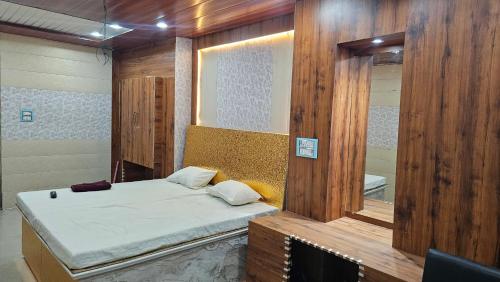 a room with a bed and a mirror at Yatri room in Varanasi