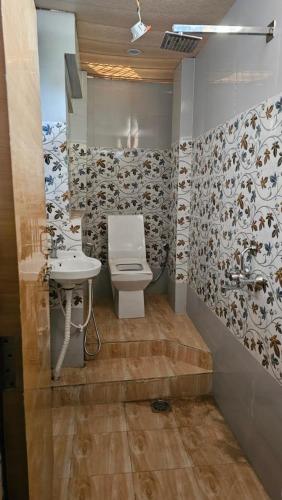 a bathroom with a toilet and a sink at Yatri room in Varanasi