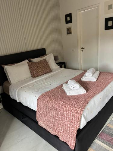 a bedroom with a bed with two towels on it at Refúgio da Vila - Refuge of the Village in Vouzela