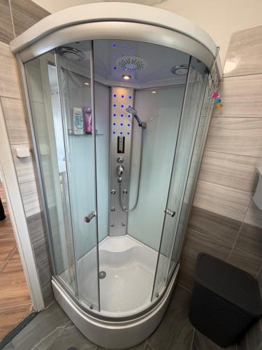 a shower with a glass door in a bathroom at Fifteenapartman in Balatonföldvár
