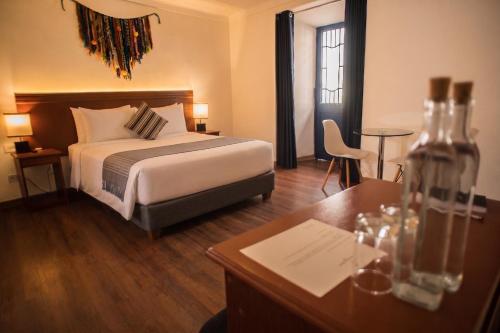 a hotel room with a bed and a desk with a desk at Hotel Ferre Cusco in Cusco