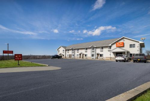 a large white building on the side of a road at Econo Lodge Inn & Suites Canandaigua - Finger Lakes Area in Canandaigua