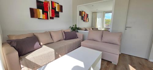 a living room with a couch and a table at Departamento PH en Martinez in Martínez