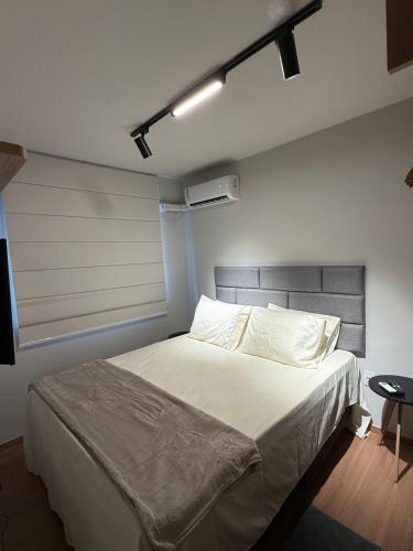 a bedroom with a large bed with white sheets at 098house havana in São Luís