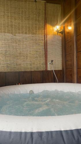 a hot tub in a room with a window at Cabaña 1 Alajuela, San Carlos, Venecia, Marsella in Pueblo Nuevo