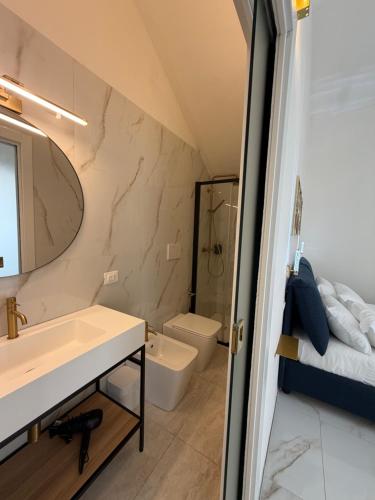 a bathroom with a sink and a mirror at Ippolita Palace LUXURY ROOMS in Otranto