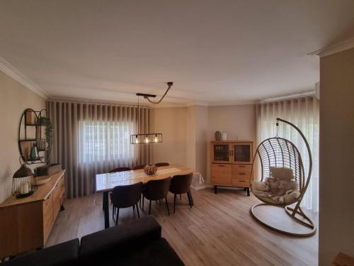 a living room with a dining room table and chairs at Diamante house com garagem privada in Braga