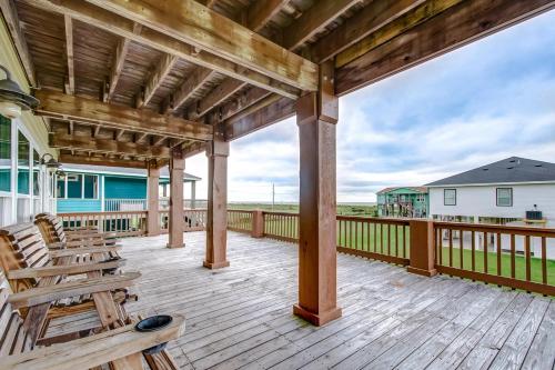 a wooden deck with chairs on it at Oceanview home in Crystal Beach