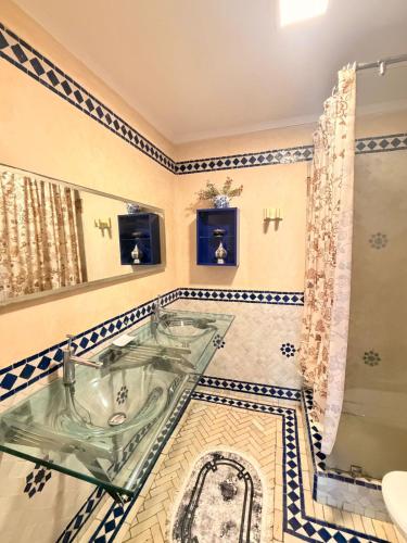 a bathroom with a glass sink and a shower at إقامة أطلس جيليز in Oulad Akkou