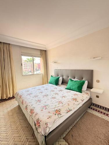 a bedroom with a large bed with green pillows at إقامة أطلس جيليز in Oulad Akkou