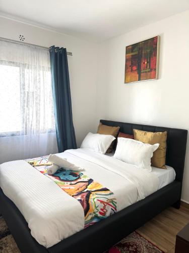 a bedroom with two beds and a window at The Spring Collection in Tatu City