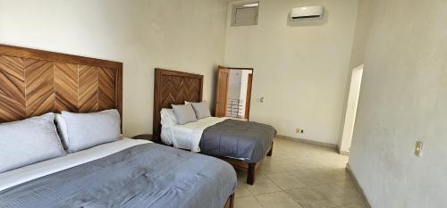 a hotel room with two beds in a room at Casa Velero in Puerto Vallarta