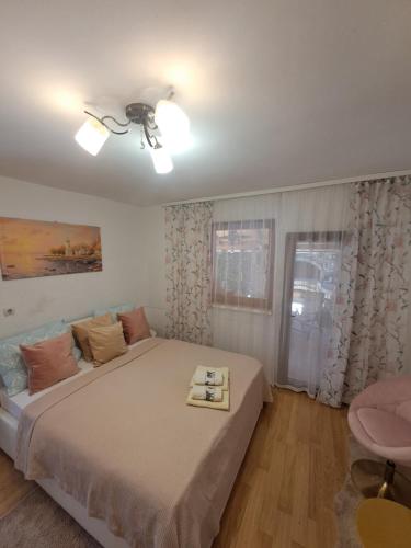 a bedroom with a large bed and a window at Lavanda in Vukovar