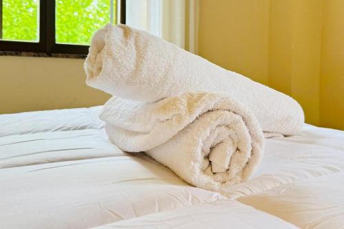 a pile of towels sitting on top of a bed at Hotel Punta Me Torreblanca Palace in Guadarrama